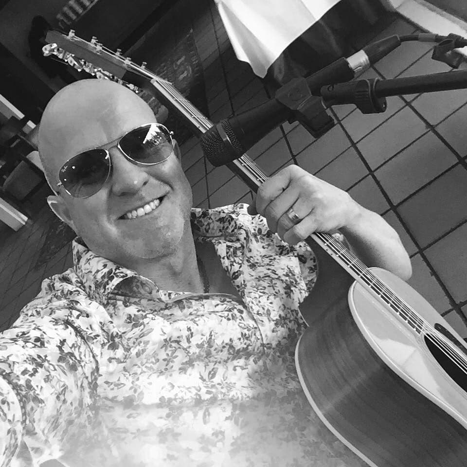 Portrait of Adam with his guitar